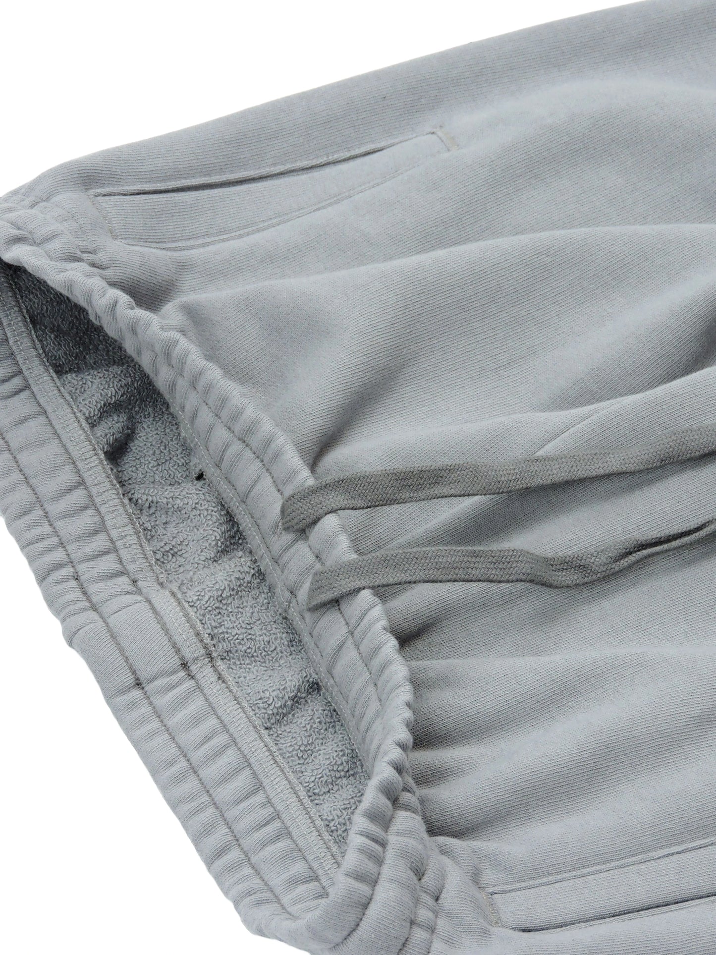 Width of pants, showing elastic-fit waistband and french terry loopings along the interior of pants