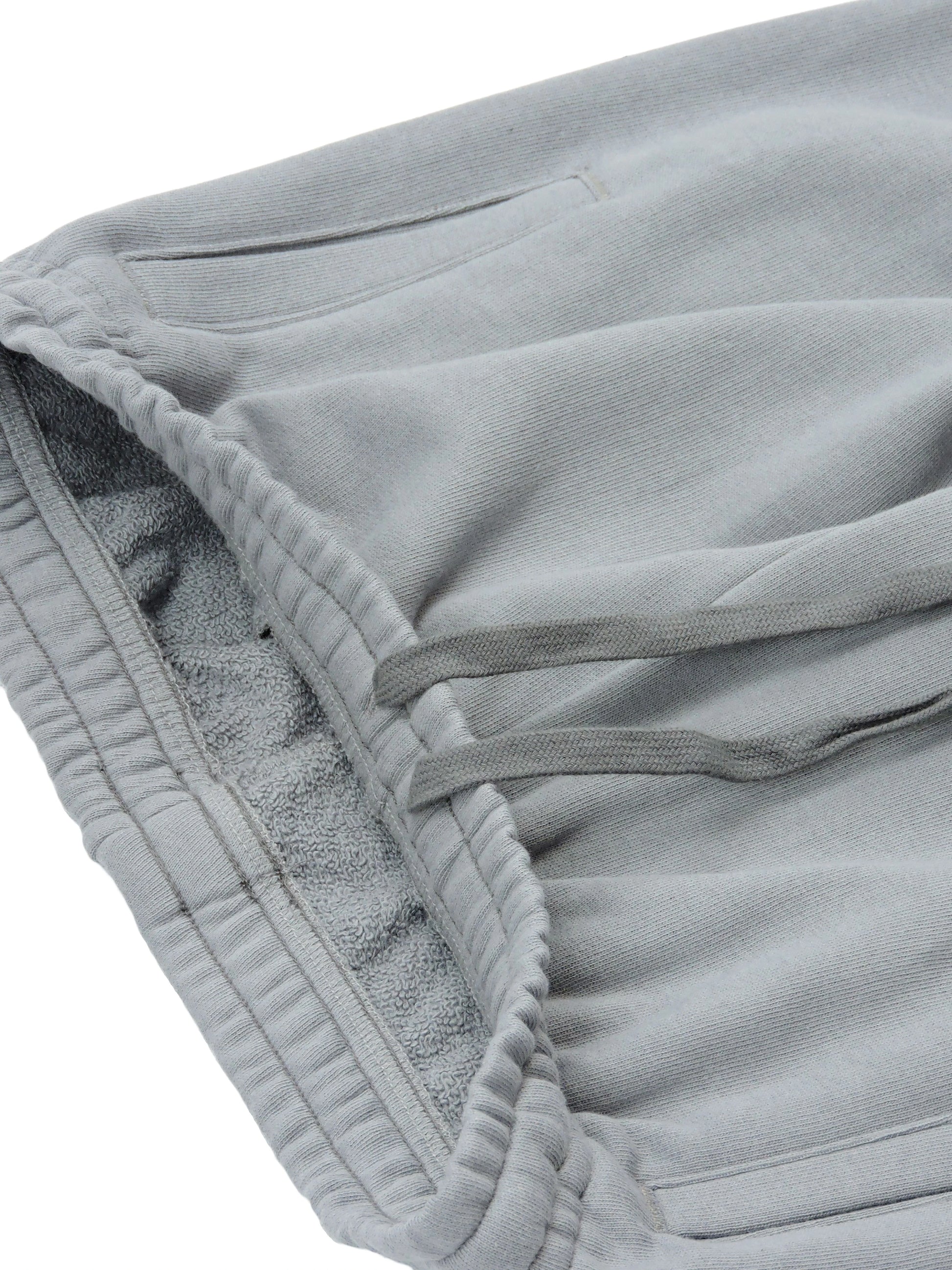 Width of pants, showing elastic-fit waistband and french terry loopings along the interior of pants