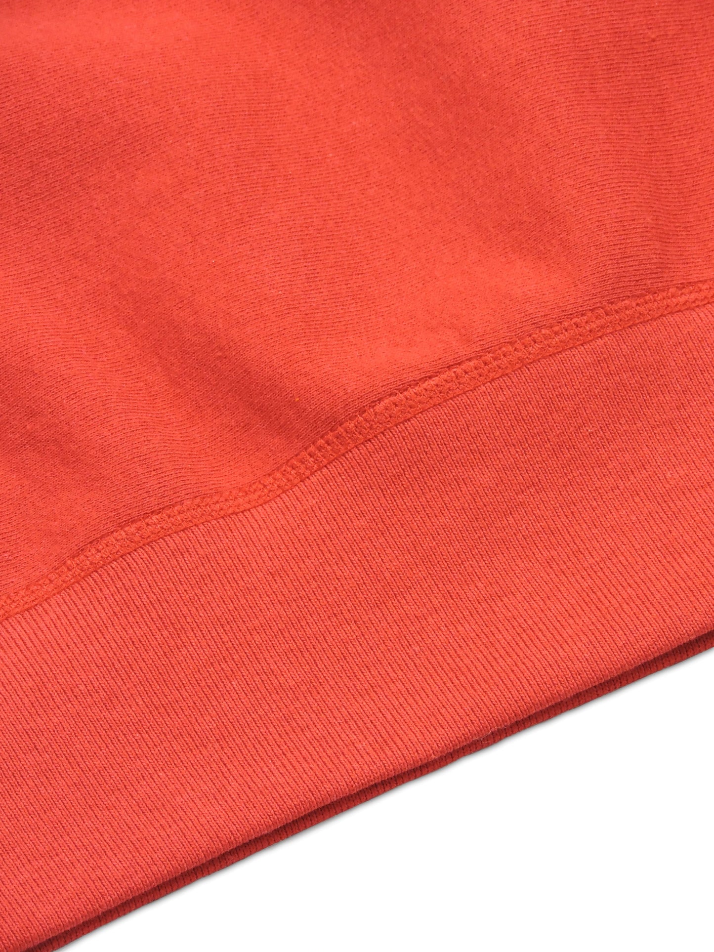 Seams around the waistband of the crewneck sweater
