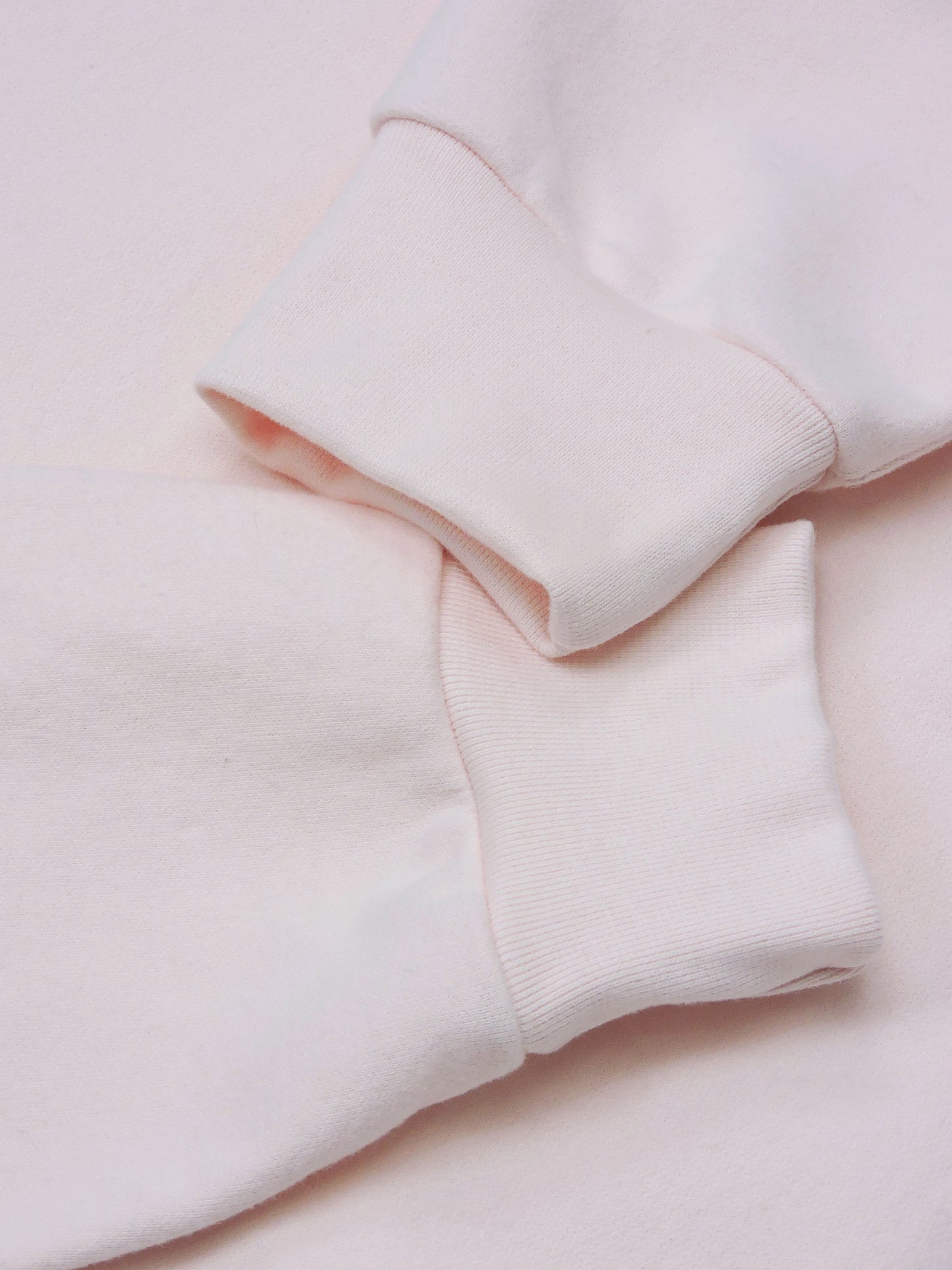 Fitted ankle cuffs drapped over the sweater. Close up of cotton material