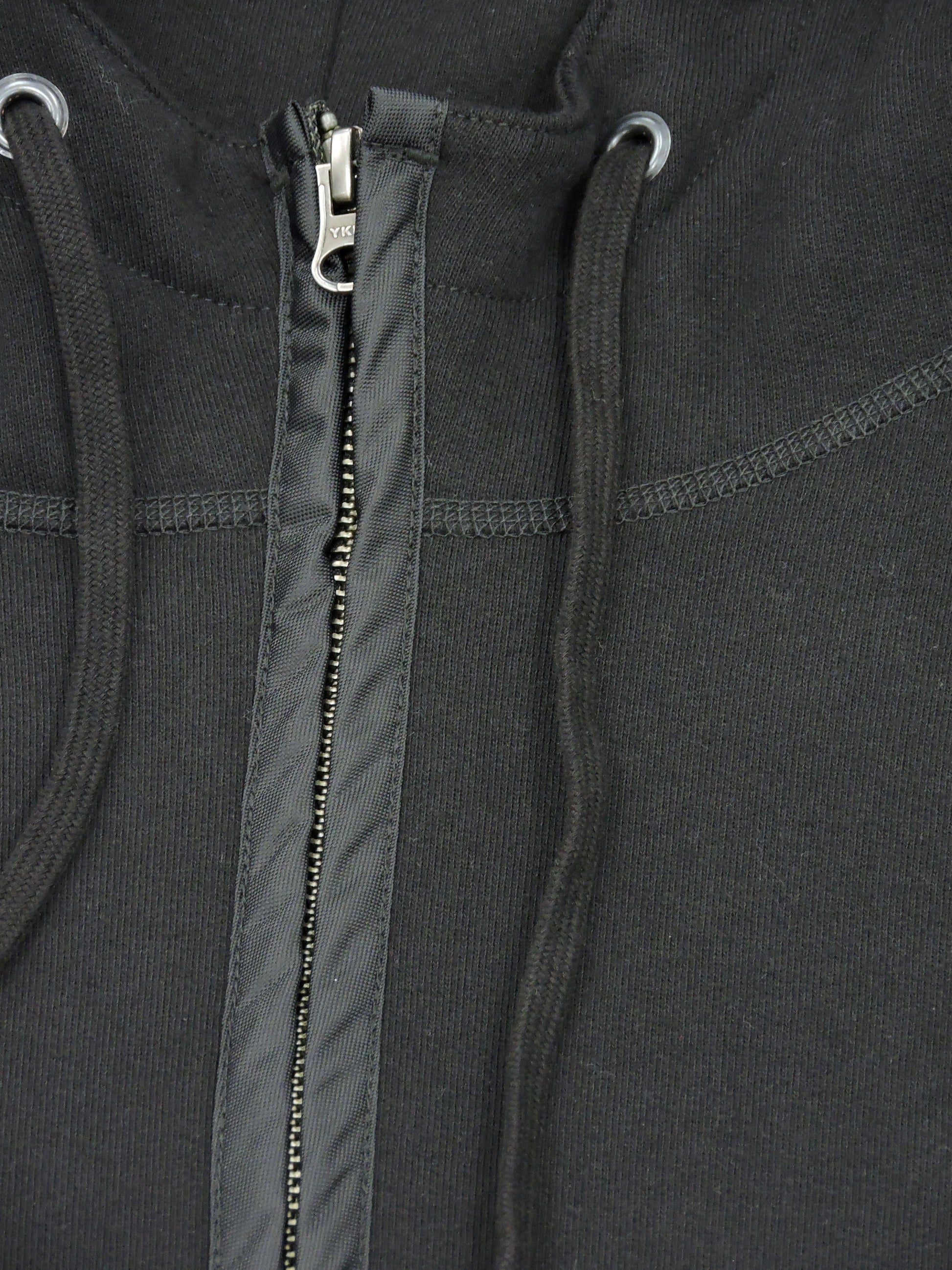 Close up of zipper, drawstrings, and fleece material.