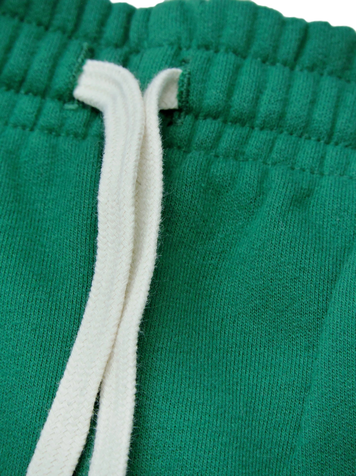 Close up of drawstrings and green cotton fabric