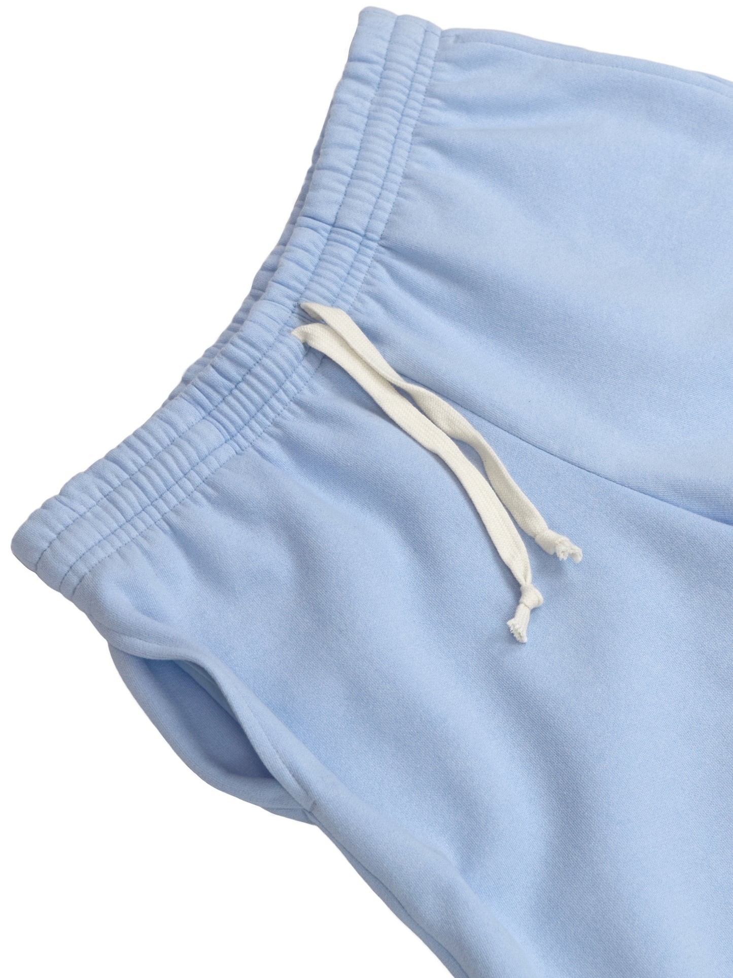 Close up of airy blue longshorts, showing texture of cotton fabric.