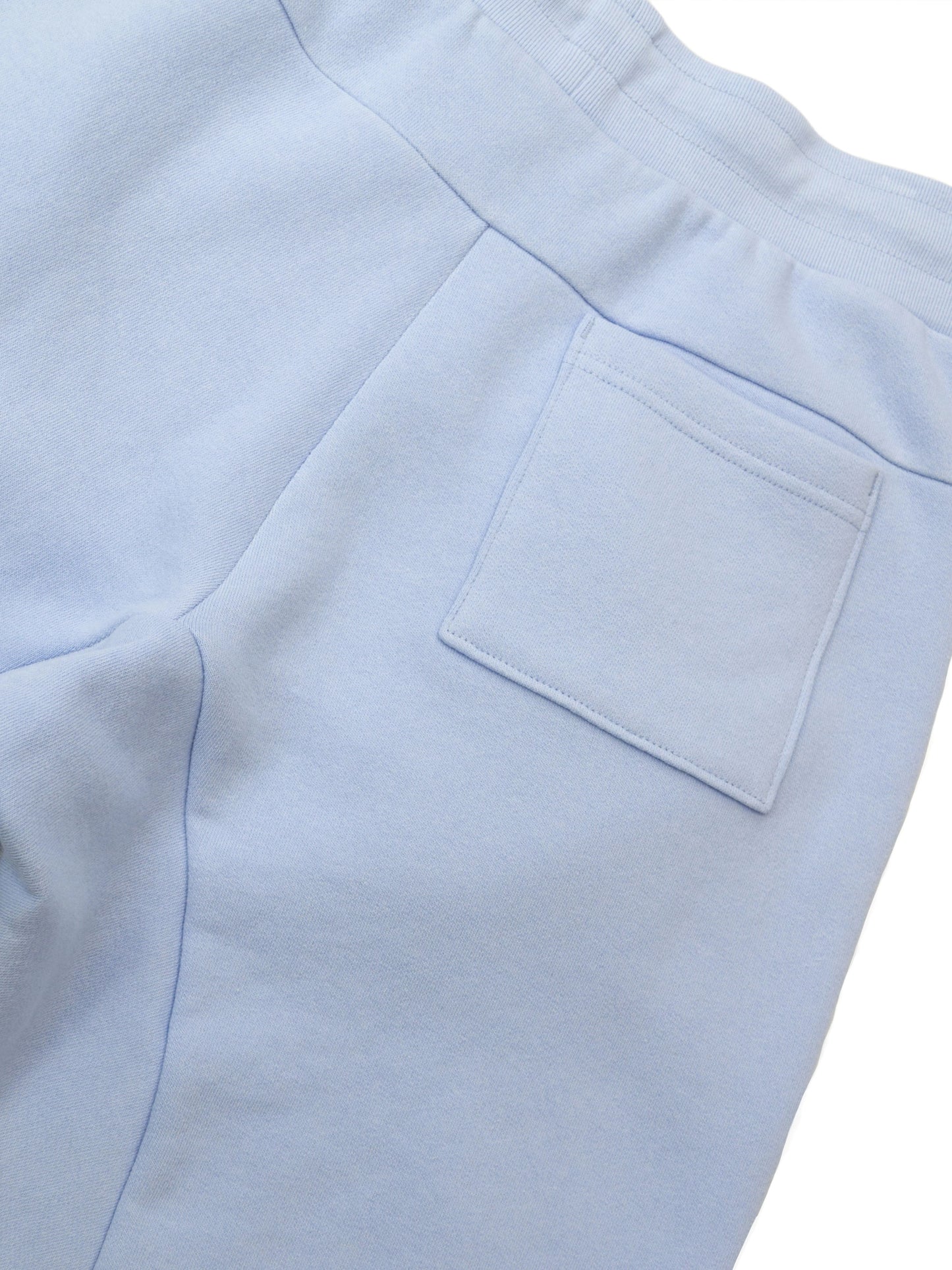 Back pocket and inseams of joggers in airy blue.