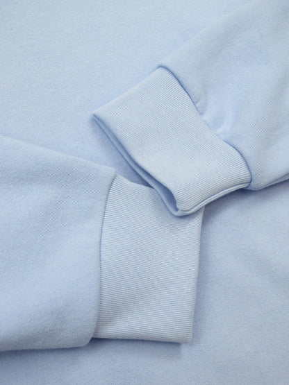 Ribbed cuffs of airy blue crewneck